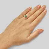 Vintage round cut emerald ring in platinum with floral engraving