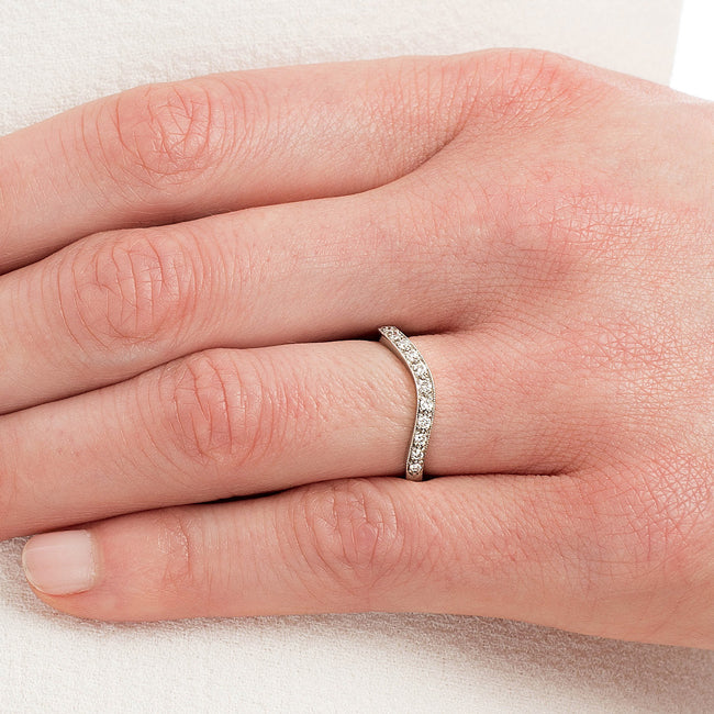 Platinum shaped wedding ring with vintage milgrain on ladys hand
