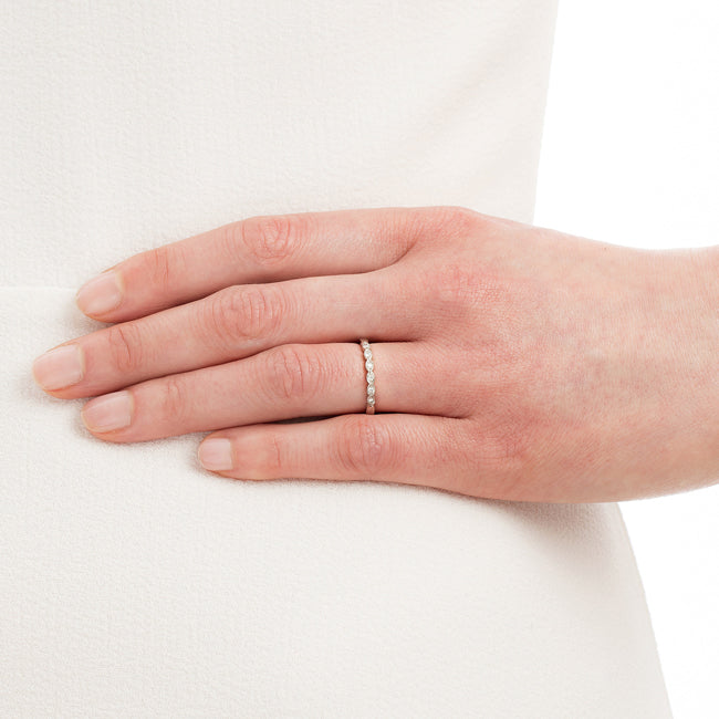 6 diamond platinum wedding ring with milgrain beads on hand