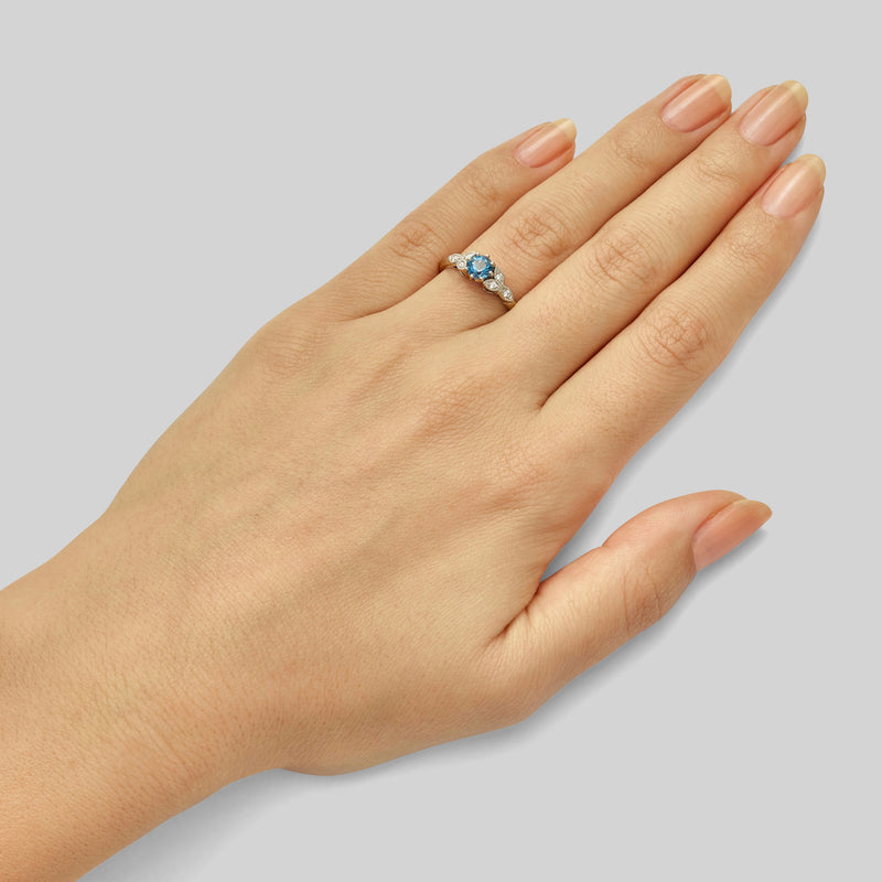 Floral platinum aquamarine ring with diamonds