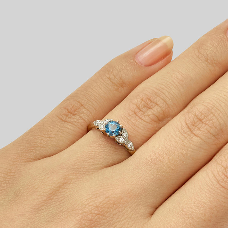 Round aquamarine engagement ring in flower design