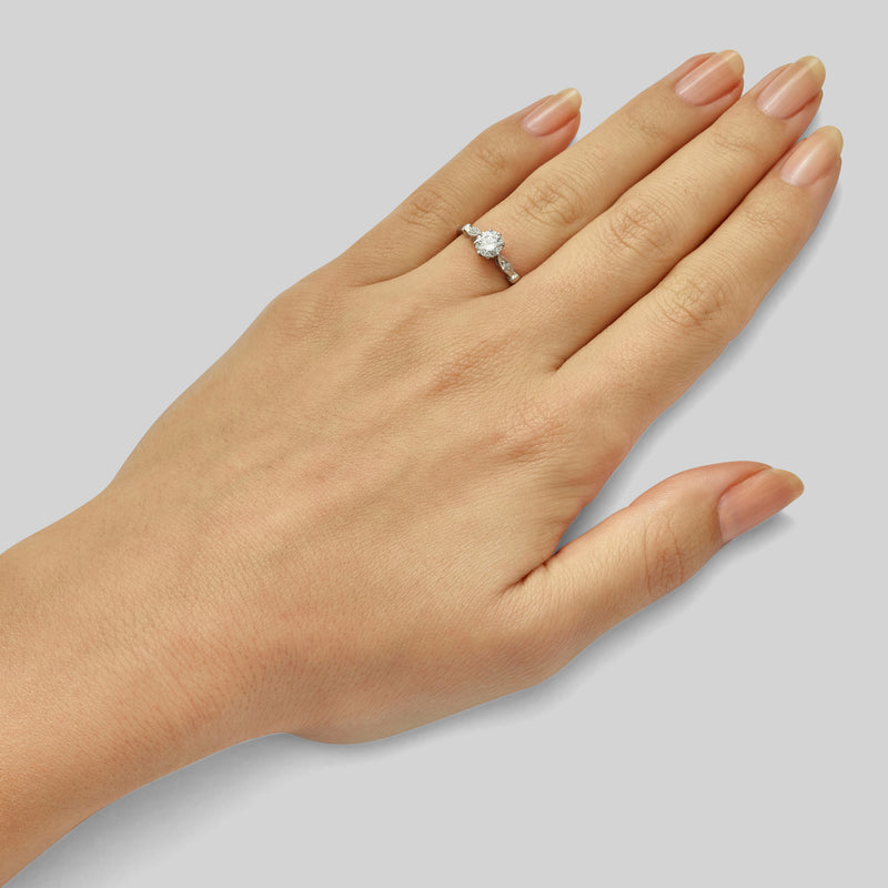 Edwardian platinum engagement ring with marquise shape shoulders