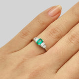 Art deco emerald and diamond five stone ring on hand