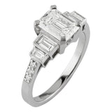 Platinum emerald cut diamond ring with baguette shoulders and diamond band