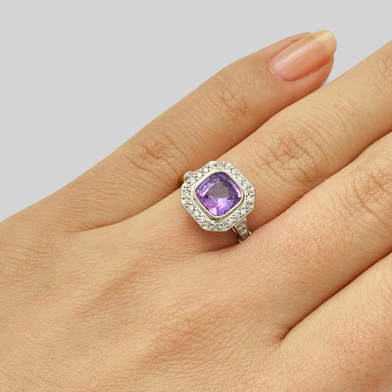Purple sapphire ring with diamond halo