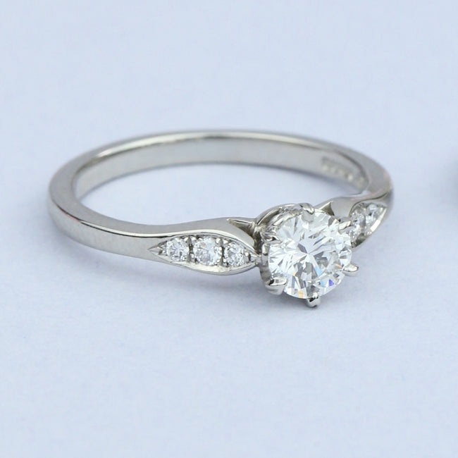 Solitaire ring with diamond band