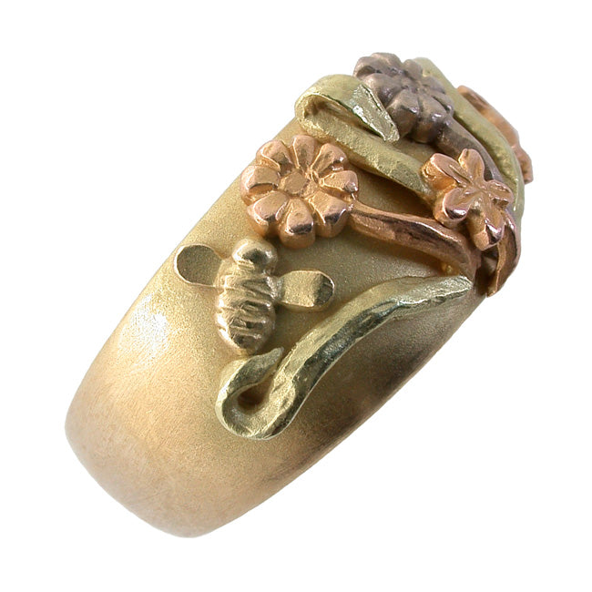 Angle view three tone gold flower ring