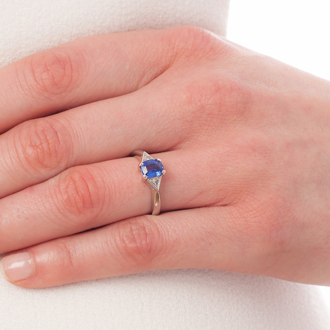 Blue sapphire ring with trillion diamonds on hand