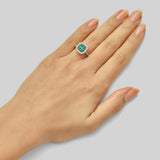 Emerald and diamond art deco cluster ring platinum on hand