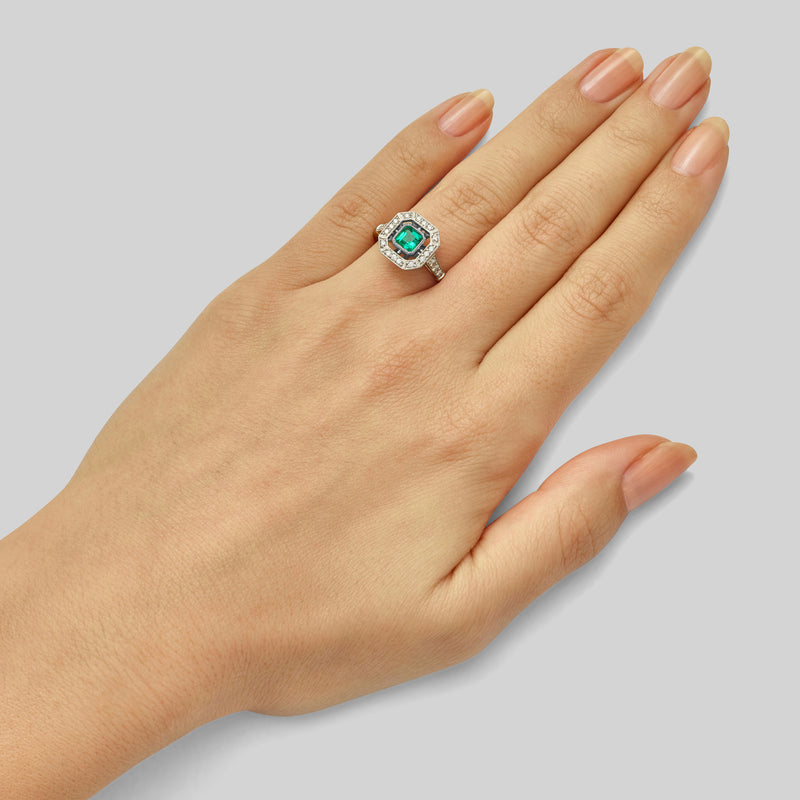 Emerald and diamond art deco cluster ring platinum on hand