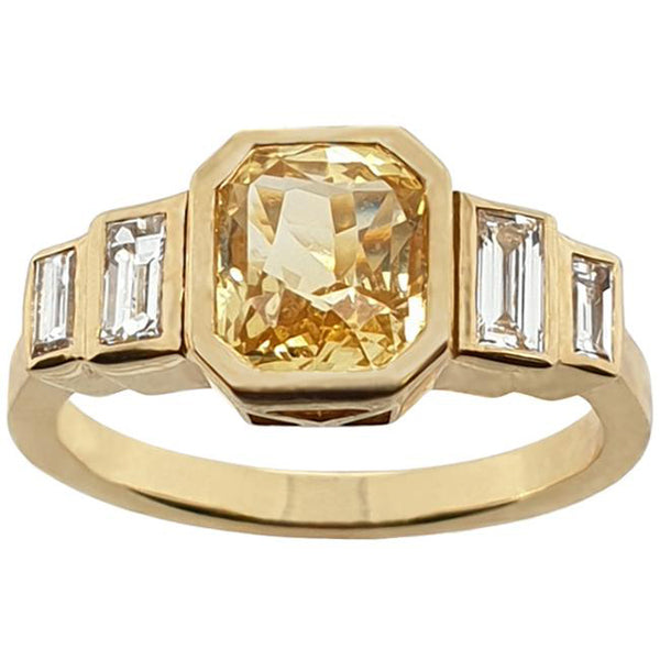 Yellow gold engagement ring with yellow sapphire and baguette diamonds