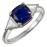 Large sapphire and triangle diamond trilogy ring