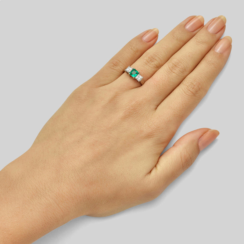 Three stone emerald and princess cut diamond ring in white gold