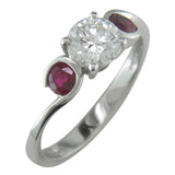 Diamond engagement ring with ruby side stones