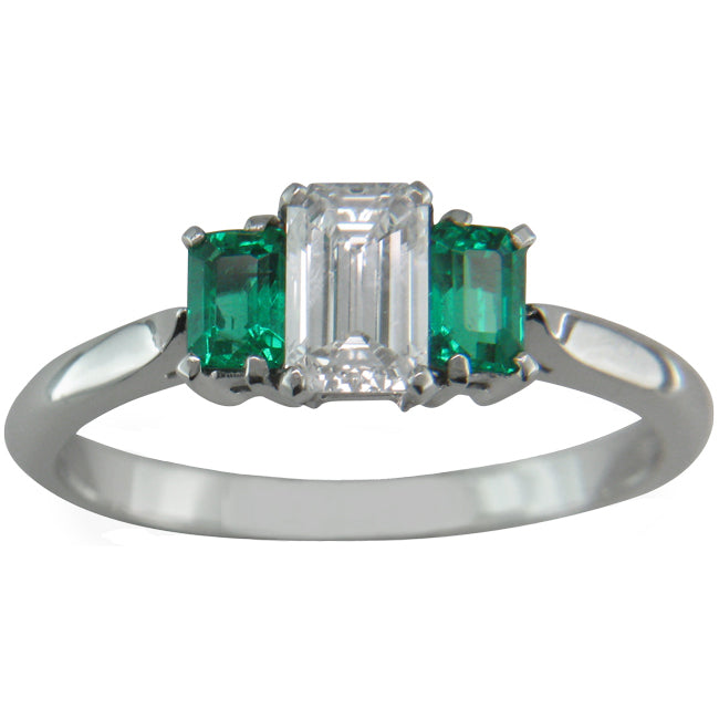 Unusual emerald cut three stone ring with emerald side stones