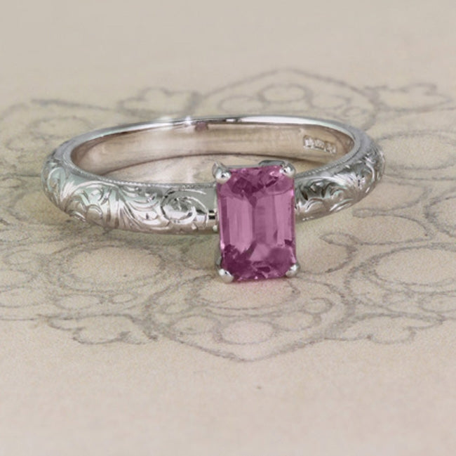 Engraved pink sapphire ring on paper