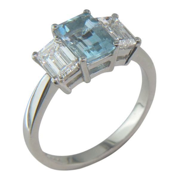 Emerald cut aquamarine three stone ring platinum