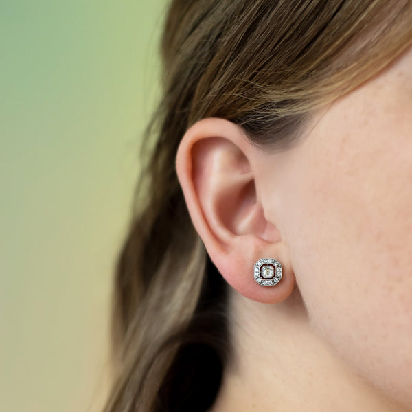 Asscher cut diamond earrings on model ear