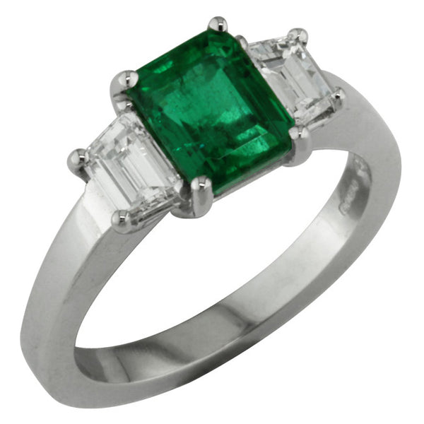 Emerald and trapezoid diamond three stone ring