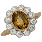 Golden sapphire and diamond halo ring