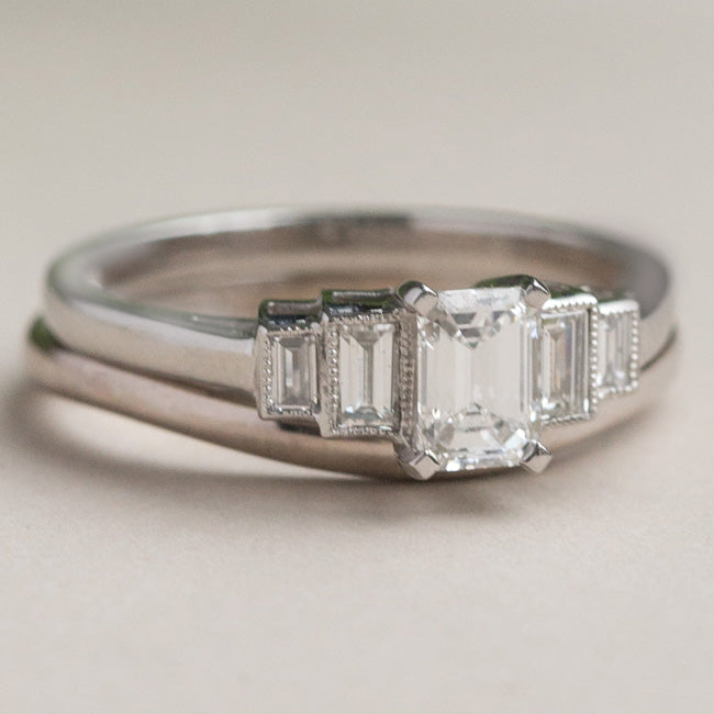 Platinum emerald cut diamond ring with complimentary wedding ring