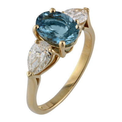 Three stone oval aquamarine and pear shape diamond ring in yellow gold